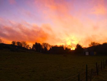 Scenic view of landscape against sky at sunset