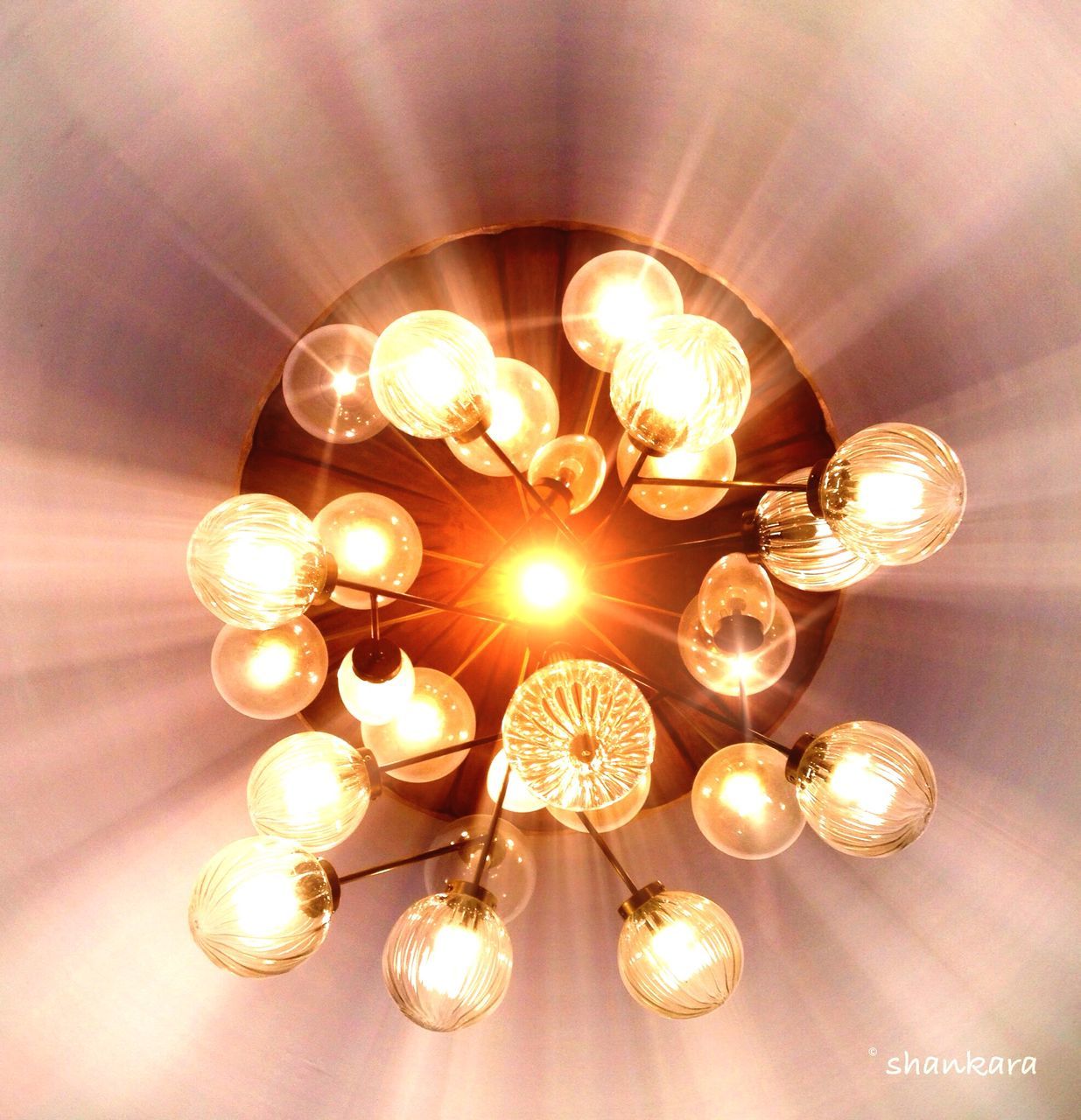 indoors, illuminated, lighting equipment, hanging, ceiling, electricity, light bulb, glowing, chandelier, low angle view, electric light, electric lamp, decoration, circle, light - natural phenomenon, lit, in a row, close-up, pendant light, light