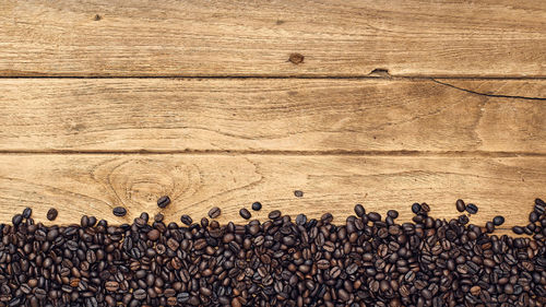 Directly above shot of coffee beans on wooden table