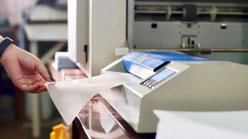 Close-up of man working on book