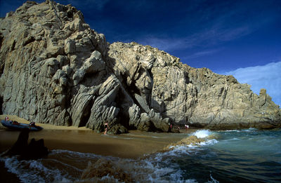 Rock formations by sea against sky