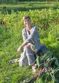 Portrait of woman sitting on field