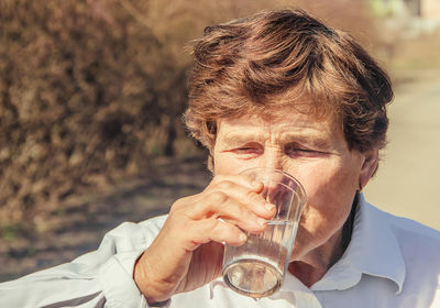 Close-up of young man drinking water