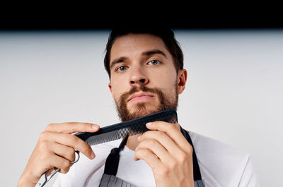 Close-up portrait of young man against white background