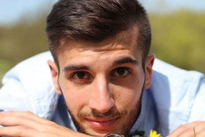 Close-up portrait of young man in sunny day