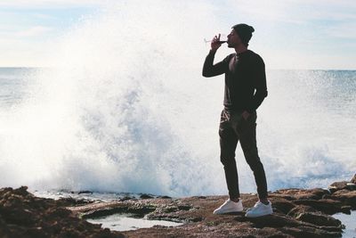 Full length of man standing on beach