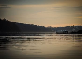 Scenic view of lake against sky during sunset