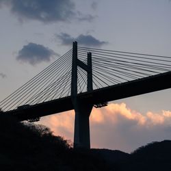 Low angle view of suspension bridge against sky
