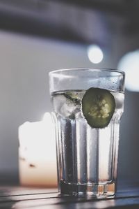 Close-up of gin tonic in glass on table