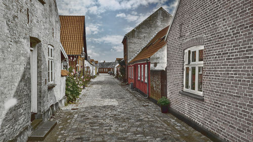 Narrow alley amidst buildings in city
