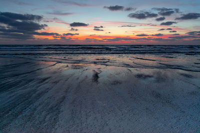 Scenic view of beach against sky during sunset