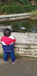 Rear view of child on lake