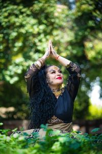Young woman wearing mask against plants