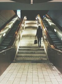 Low angle view of woman walking on steps