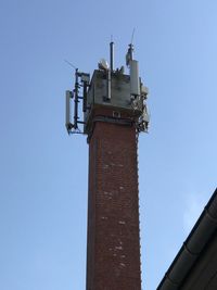 Low angle view of old building against clear blue sky