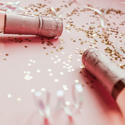 Close-up of woman hand on pink table