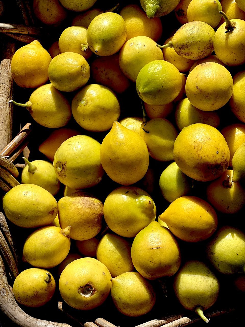 food and drink, food, healthy eating, freshness, fruit, wellbeing, plant, abundance, large group of objects, produce, citrus, yellow, no people, citrus fruit, still life, container, market, lemon, close-up, retail, organic, green, for sale, market stall, high angle view, olive