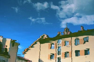 Low angle view of buildings against blue sky