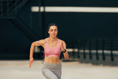 Portrait of young woman exercising in gym