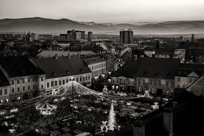 Sunset over the traditional christmas market in the historic center of sibiu, transylvania, romania.