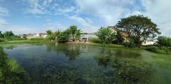 Scenic view of lake by building against sky