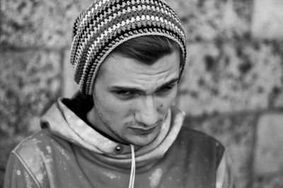 Close-up portrait of young man wearing hat