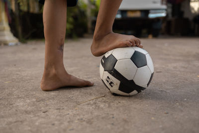 Low section of man playing soccer ball