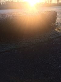 Close-up of sun on beach against sky