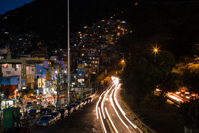 High angle view of light trails on road in city at night