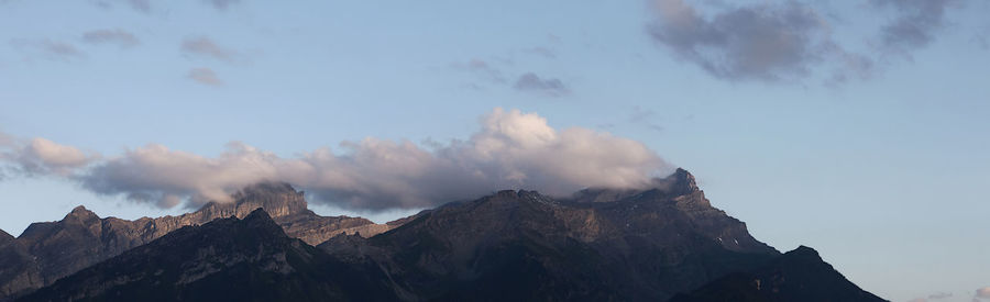 Low angle view of snowcapped mountains against sky