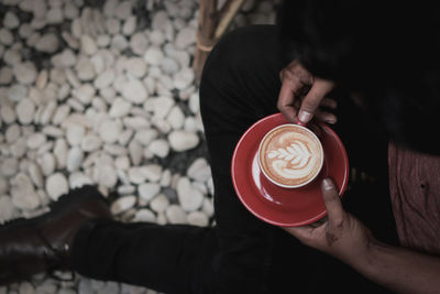 Midsection of man holding coffee cup