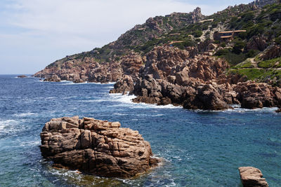 Rock formation on sea against sky