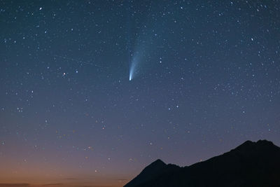 Low angle view of silhouette mountain against sky at night