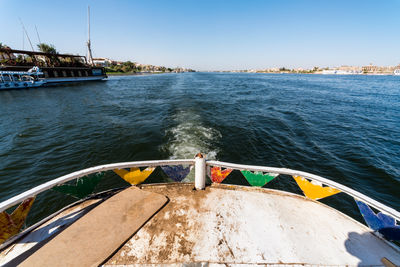 Boat sailing in sea against clear sky