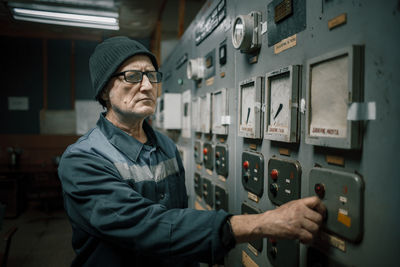 Senior technician working at factory