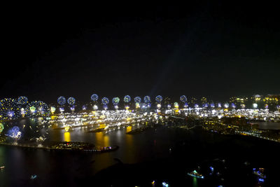 Illuminated cityscape against clear sky at night