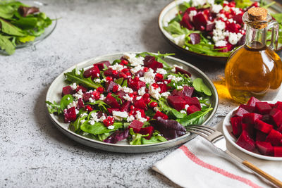 Arugula, beet and cheese salad with pomegranate and dressing 