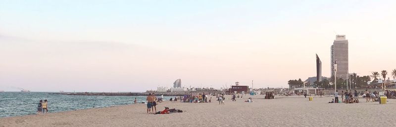 People on beach against sky