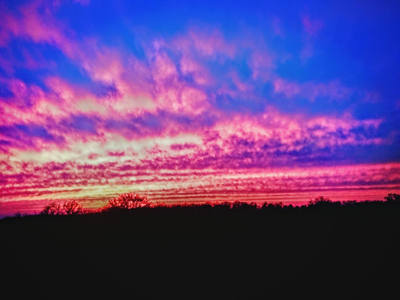 SILHOUETTE LANDSCAPE AGAINST DRAMATIC SKY