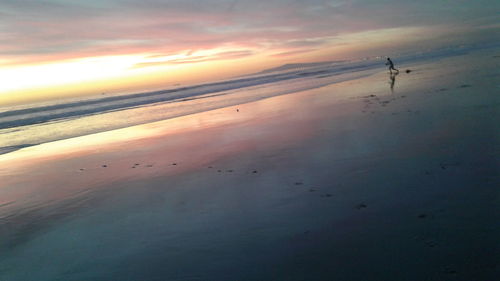 Scenic view of beach against sky during sunset