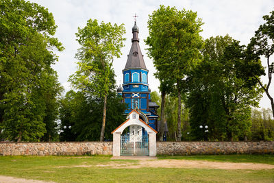 Low angle view of church amidst trees