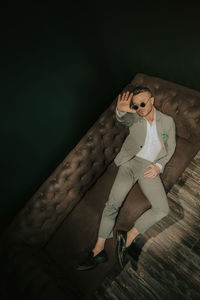 Portrait of young man sitting on floor