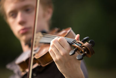 Close-up of man playing violin