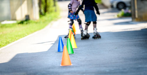 Low section of people skating on road