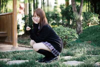 Young woman sitting outdoors