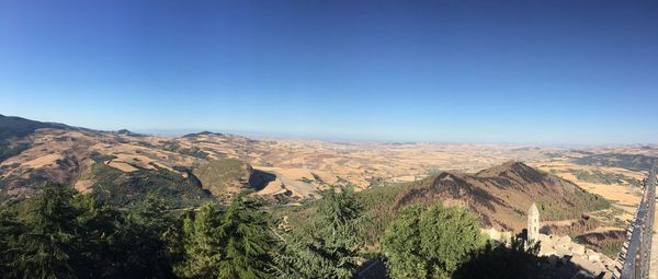 Panoramic view of landscape against clear blue sky