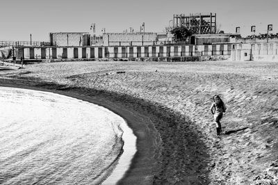 Man on beach against clear sky