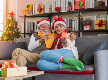 Portrait of smiling man sitting on sofa