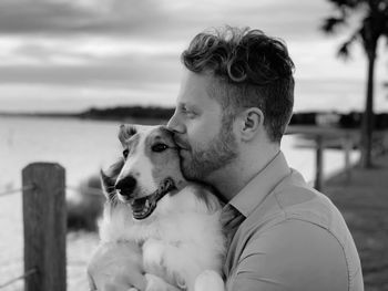 Man with dog against blurred background