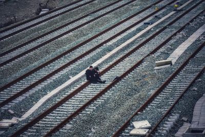 High angle view of people walking on railroad tracks